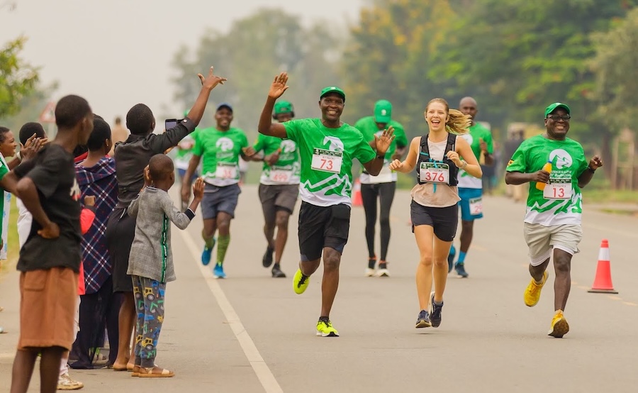 Runners being cheered on by a roadside crowd